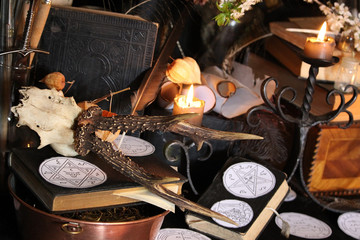 Black candle Magic Ritual. Antique Magic Book. Witchcraft  Peacock feathers and candle background.