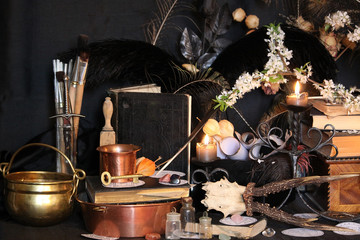 Black candle Magic Ritual. Antique Magic Book. Witchcraft  Peacock feathers and candle background.