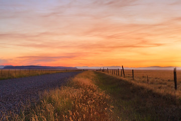 Road And Fence At Sunset