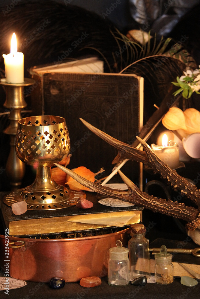 Wall mural Black candle Magic Ritual. Antique Magic Book. Witchcraft  Peacock feathers and candle background.