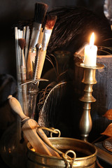 Black candle Magic Ritual. Antique Magic Book. Witchcraft  Peacock feathers and candle background.