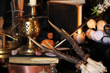 Black candle Magic Ritual. Antique Magic Book. Witchcraft  Peacock feathers and candle background.