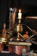 Black candle Magic Ritual. Antique Magic Book. Witchcraft  Peacock feathers and candle background.