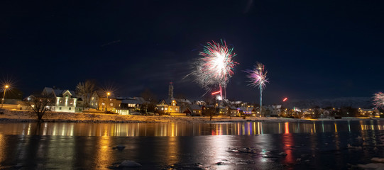 Fototapeta na wymiar Celebration of New Year's Eve with fireworks in Bonnoysund, Northern Norway