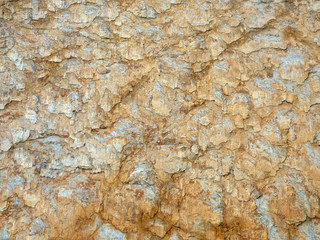 Mountain rock with grey, white, brown stones. Background, macro, Caucasus