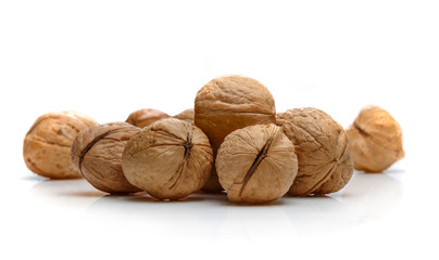 A pile of walnuts on a white background