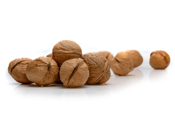 A pile of walnuts on a white background
