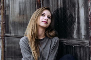 Fototapeta premium Cute romantic girl sitting near the old window
