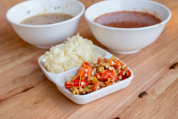 Red sauce with chilli for seafood Shabu on wooden table