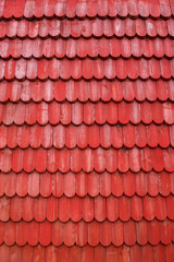 red wooden shingles on a wall 
