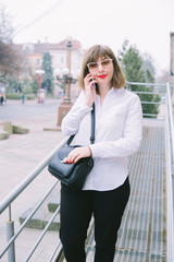 Fototapeta premium business woman with phone walk in the city