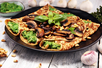 Savory Homemade Mushroom and Spinach Crepes with Cheese and avocado.