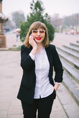 business woman with phone walk in the city