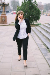 business woman with phone walk in the city