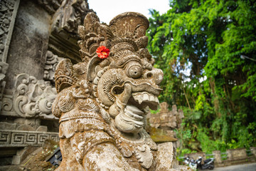Traditional Balinese guardian statue at entrance of Pura Gunung Lebah temple in Ubud, Bali island, Indonesia