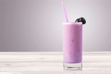 Glass of blueberry smoothie isolated on white background