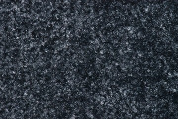 Texture of a swatch of thick smoky black floor mat with light-colored gray flecks in it.
