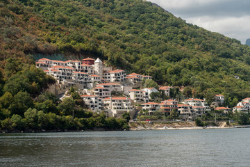 Fototapeta na wymiar Villas and apartments at waterfront, Bay of Kotor, Montenegro