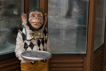 Close-up of chimpanzee butler statue at a restaurant, Budva, Montenegro - 233433540