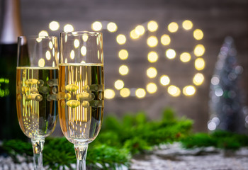 Moody new year decoration concept-glass of champagne on blurred new year background.
