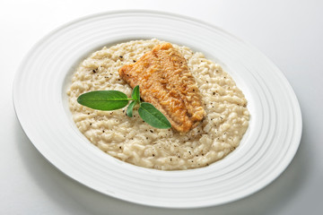 Dish of Parmesan risotto with fish fillet