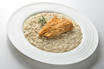 Dish of Parmesan risotto with fish fillet