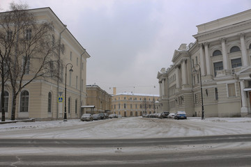 Fototapeta na wymiar urban snow covered area with parked cars