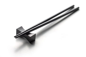 Black chopsticks on a white background