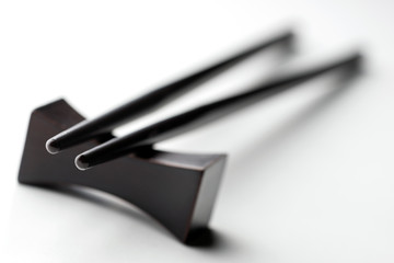 Black chopsticks on a white background