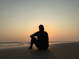 man on the beach enjoying sunset