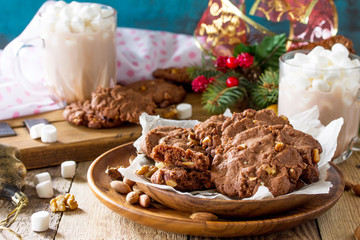 Baked Christmas cookies. Homemade Chocolate Chip Cookies with Nuts on a wooden table.