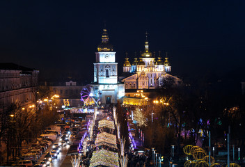 Christmas tree decorated with lights and Sophia Cathedral on background. Kiev, Ukraine