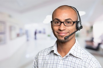 Portrait of a smiling man with headset working as a call center