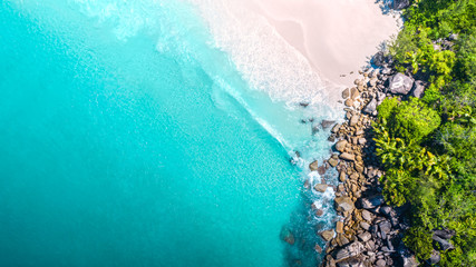 Tropical beach with sea and palm taken from drone. Seychelles famous shark beach - aerial photo