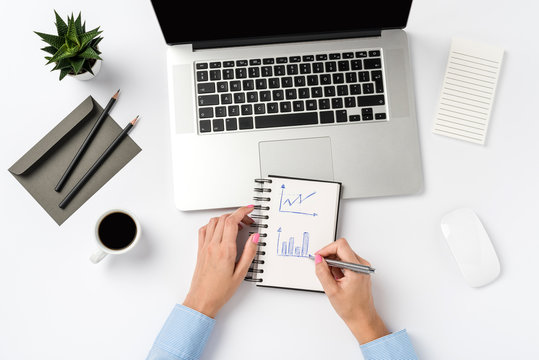 Overhead shot of woman working in office. Copy space