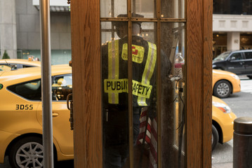 Security officer standing in a booth, New York City, New York State, USA