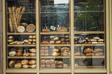 Tuinposter Various type of breads on display at a bakery, New York City, New York State, USA © klevit