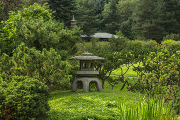 Fototapeta na wymiar Stone lantern in a Japanese garden on a summer day.
