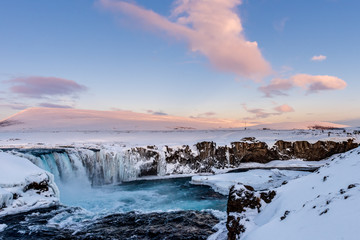 Frozen Godafoss waterfall on cold winters day at dawn, Northern Iceland