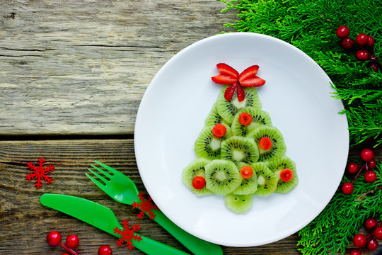 Christmas tree kiwi strawberry fruit snack for kids, creative idea for Christmas and New Year festive meal