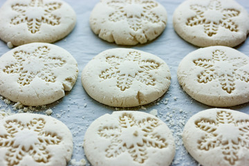 Christmas snowflake cookies, homemade round white biscuits with snowflake ornament