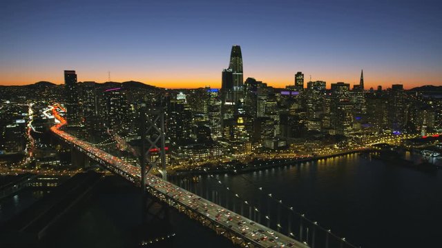 Aerial night view Bay bridge San Francisco skyscrapers