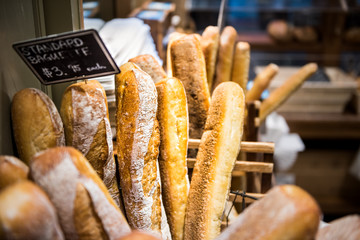 Closeup of fresh golden standard baked baguette loaves in bakery basket