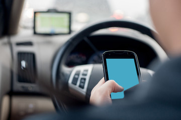 Man in Car's Hand Using Cellphone While Behind The Wheel, Automated Or Distracted Driving Concept