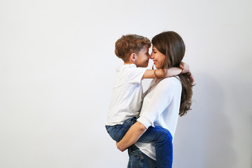  Mother holding her preteen son smiling and looking into his eye