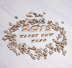 Congratulations with new 2019 year made of wooden letters on a light background