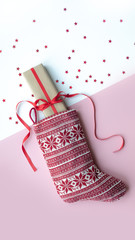 Red christmas sock with gifts on a light background. Christmas background with copyspace.