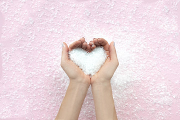 Woman's hands hold snow, winter concept.