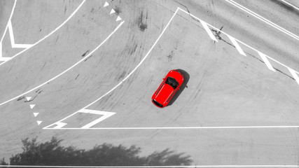 Aerial view of highway. Aerial view of a country road with moving red car. Car passing by. Aerial...