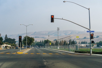 Street in East San Francisco bay area; smoke and pollution in the air from nearby wildfires; hills barely visible in the background